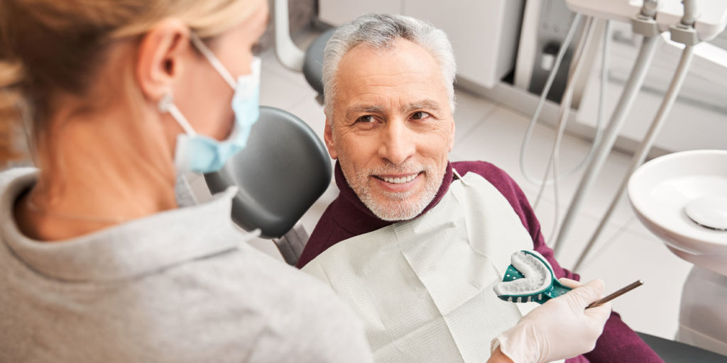 dentist taking impressions of remainingteeth for full mouth implants