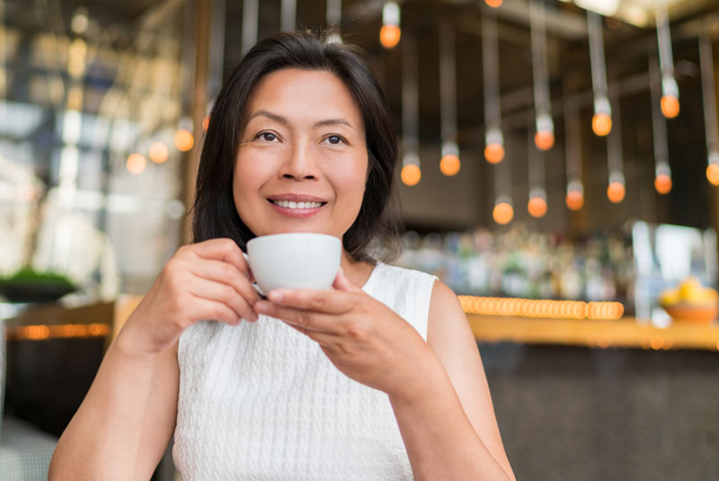 implant patient drinking hot beverage with new implants