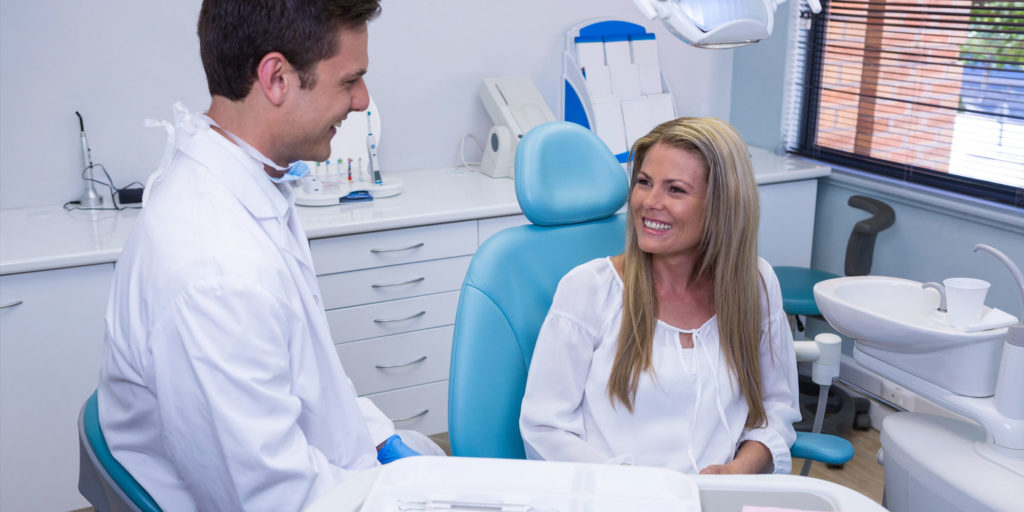 implant patient meeting with dentist after surgery