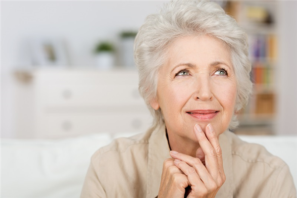 Very nice lady with white hair smiling looking up thinking