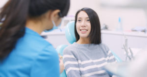 Very nice lady with dark hair smiling looking at doctor