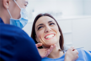 Very nice lady in dental chair smiling at doctor